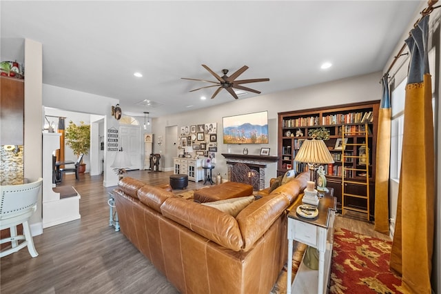 living room with wood-type flooring and ceiling fan