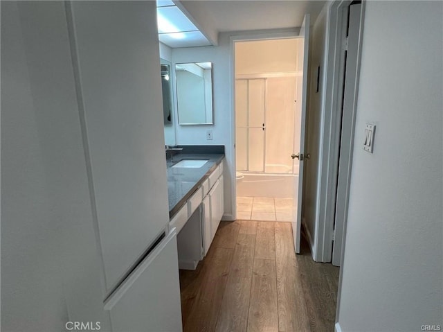 full bathroom with hardwood / wood-style flooring, vanity, toilet, and shower / tub combination