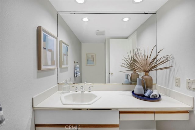 bathroom featuring vanity and recessed lighting