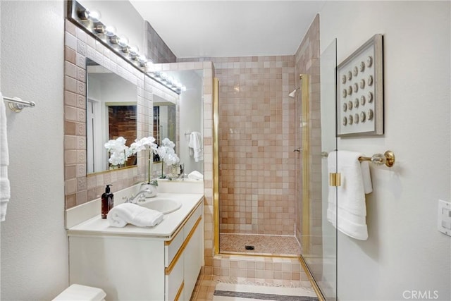 bathroom featuring a stall shower and vanity