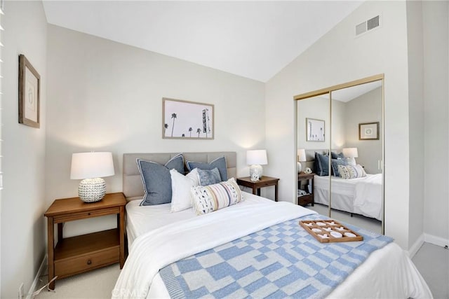 bedroom with lofted ceiling, a closet, visible vents, light carpet, and baseboards