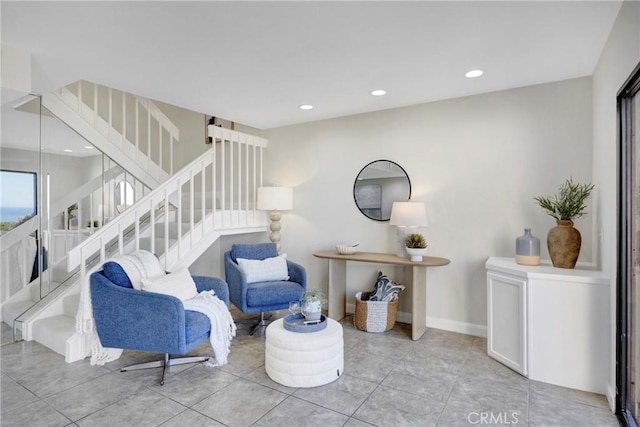 sitting room featuring recessed lighting, tile patterned floors, baseboards, and stairs