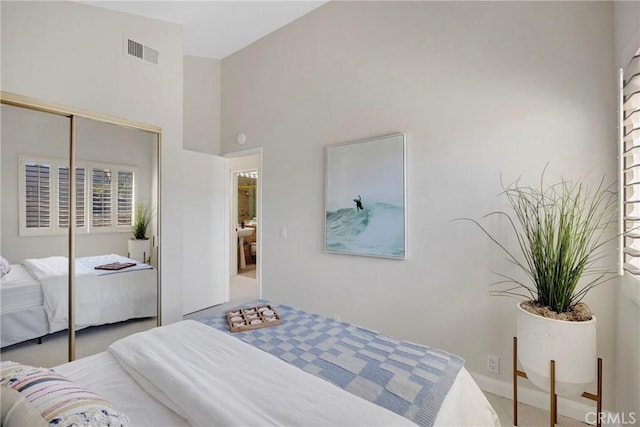 bedroom featuring a high ceiling, a closet, carpet flooring, and visible vents