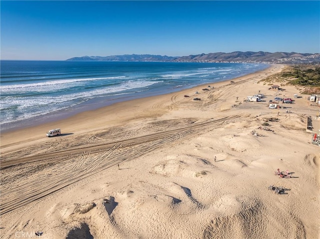 property view of water featuring a mountain view and a beach view