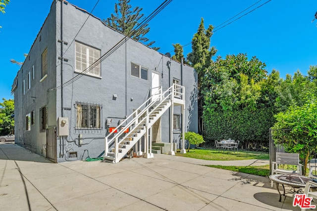 rear view of house featuring a patio