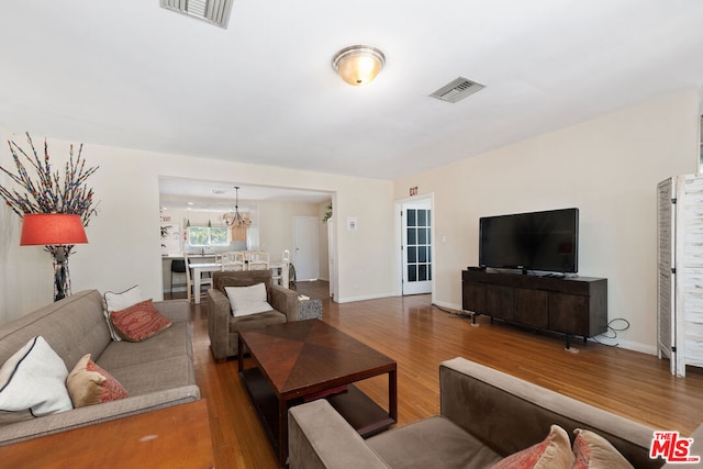 living room featuring hardwood / wood-style floors and a notable chandelier