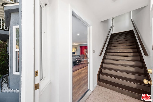 stairway featuring tile patterned floors