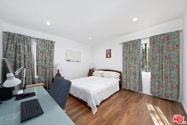 bedroom with wood-type flooring