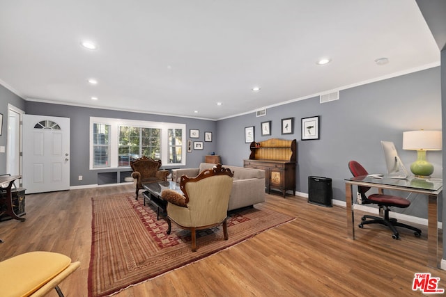 living room featuring wood-type flooring and ornamental molding