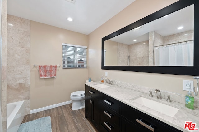 bathroom with wood-type flooring, toilet, and vanity