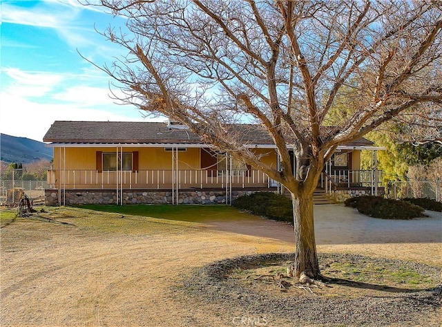 view of front of property featuring a porch and a mountain view