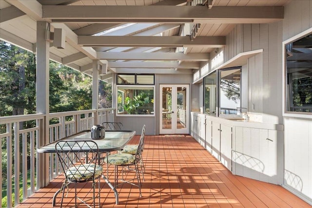 sunroom / solarium with french doors and beam ceiling