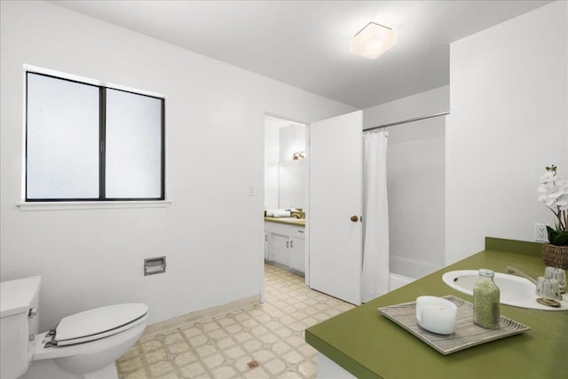 full bathroom with vanity, shower / tub combo, and toilet