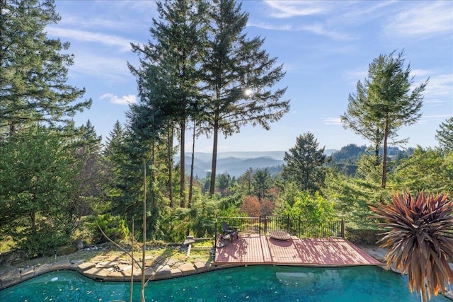 view of pool featuring a deck with mountain view