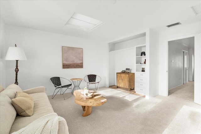 carpeted living room featuring built in features