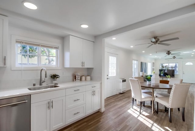 kitchen with sink, ceiling fan, dark hardwood / wood-style floors, white cabinets, and stainless steel dishwasher