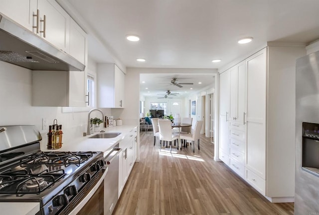 kitchen with white cabinetry, sink, ceiling fan, and appliances with stainless steel finishes