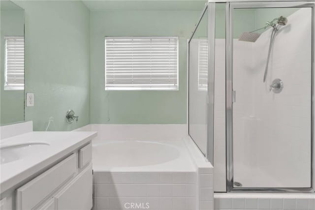 bathroom with vanity and independent shower and bath