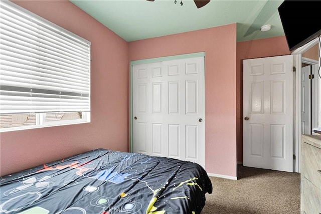 bedroom featuring carpet, ceiling fan, and a closet