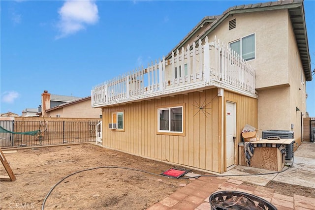 rear view of house featuring an outdoor fire pit