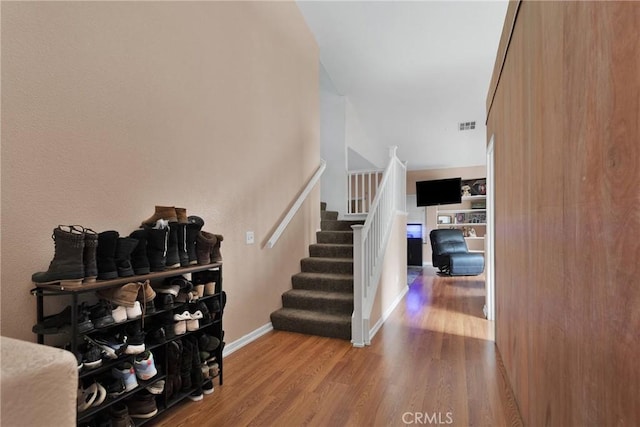 stairs with hardwood / wood-style flooring