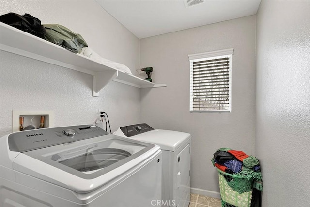 clothes washing area with separate washer and dryer