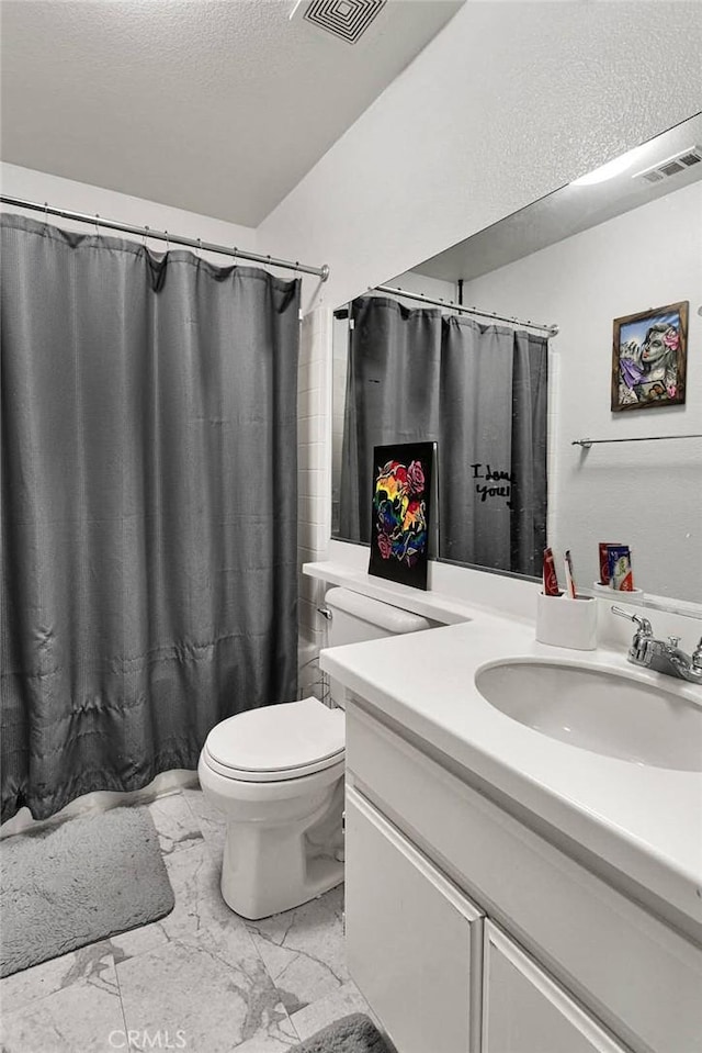 full bathroom with vanity, shower / tub combo, a textured ceiling, and toilet