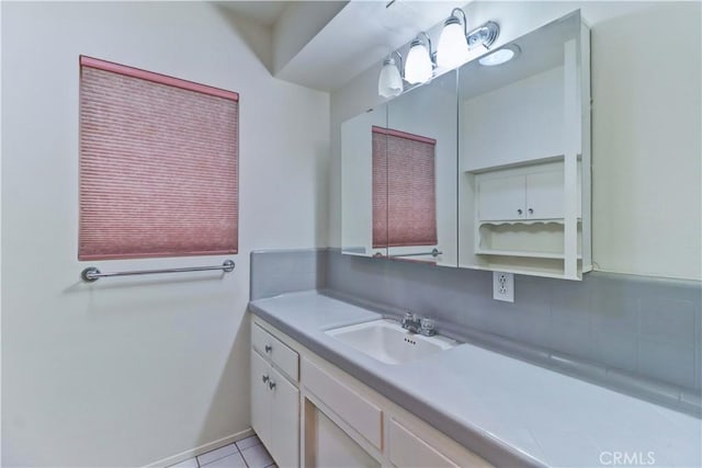 bathroom with vanity, tile patterned flooring, and decorative backsplash