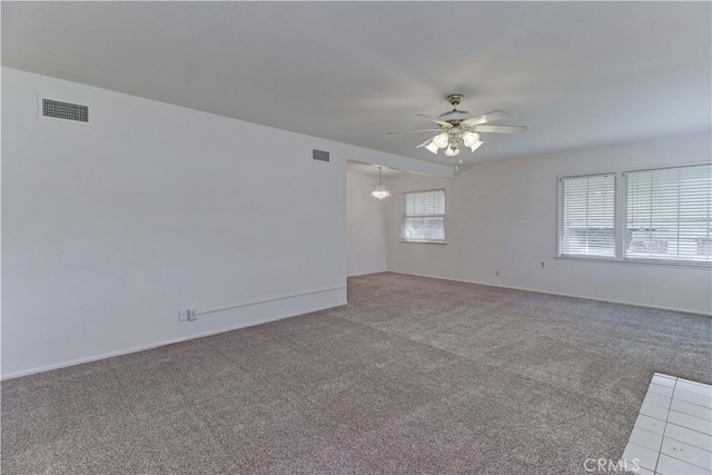 unfurnished room featuring ceiling fan and carpet floors