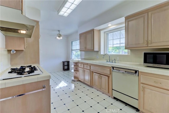 kitchen with sink, white appliances, and light brown cabinets