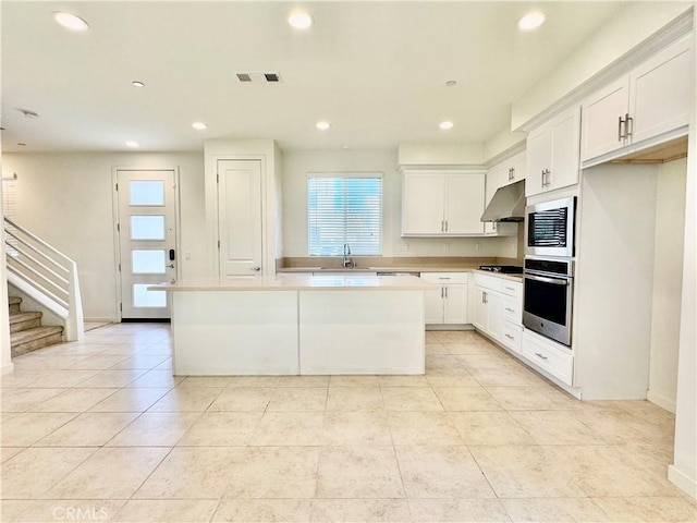 148 Stage, Irvine, CA 92618 - kitchen featuring sink, a center island, stainless steel oven, and white cabinets