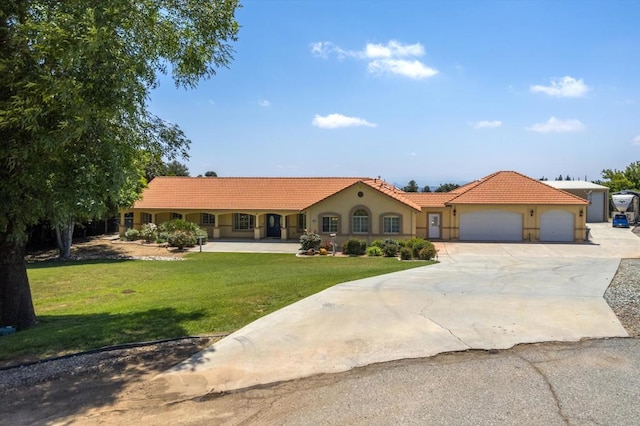 view of front facade with a garage and a front lawn