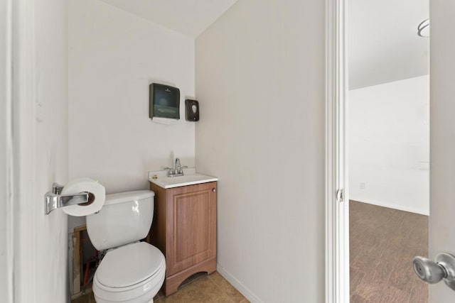 bathroom with tile patterned floors, vanity, and toilet