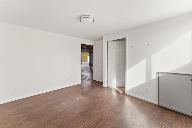 unfurnished room featuring dark hardwood / wood-style floors