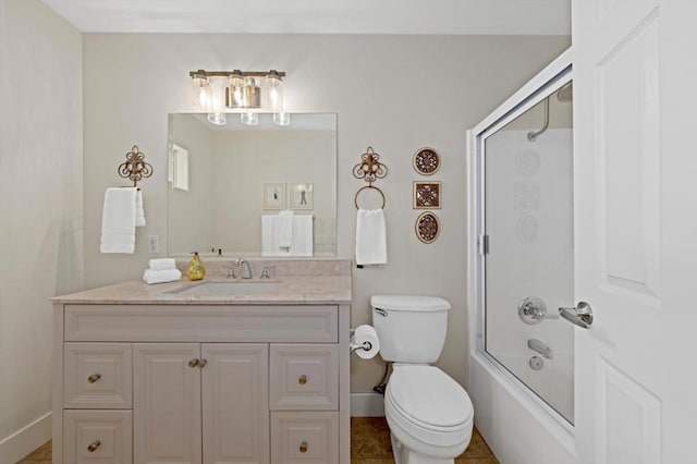 full bathroom featuring enclosed tub / shower combo, vanity, and toilet