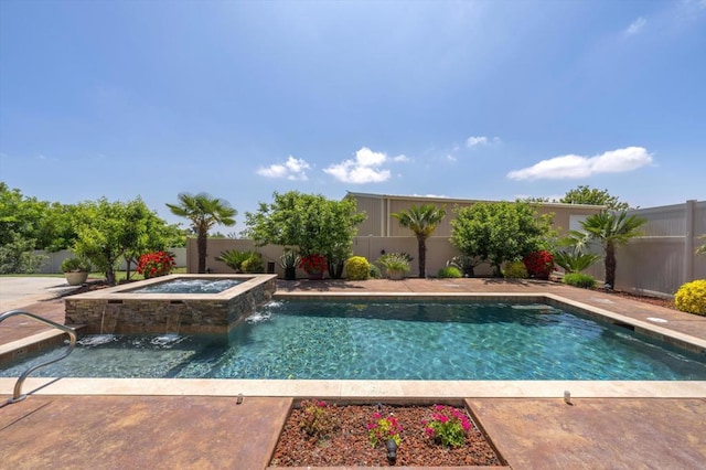 view of swimming pool with pool water feature and an in ground hot tub