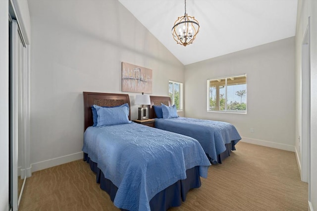 bedroom featuring a closet, high vaulted ceiling, light carpet, and a notable chandelier