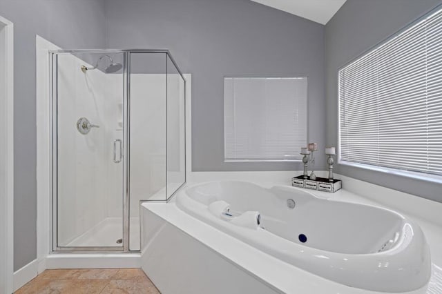 bathroom with lofted ceiling, tile patterned floors, and shower with separate bathtub