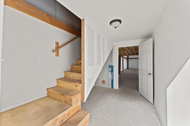 stairway featuring concrete floors