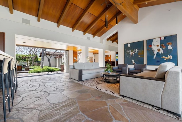 living room featuring beamed ceiling, wood ceiling, and high vaulted ceiling