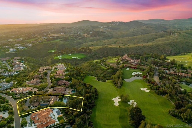 aerial view at dusk featuring a mountain view