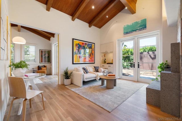 living room featuring high vaulted ceiling, beam ceiling, light hardwood / wood-style floors, and wooden ceiling