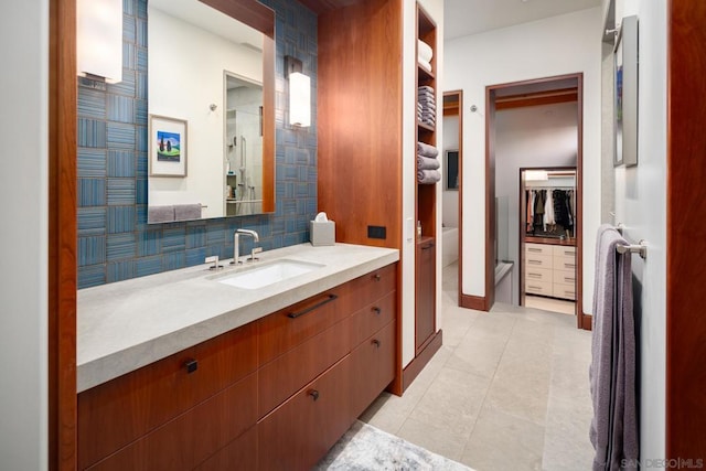 bathroom featuring tile patterned floors, vanity, and decorative backsplash