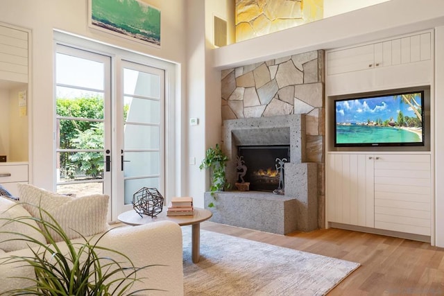 living room featuring light hardwood / wood-style flooring and a high ceiling