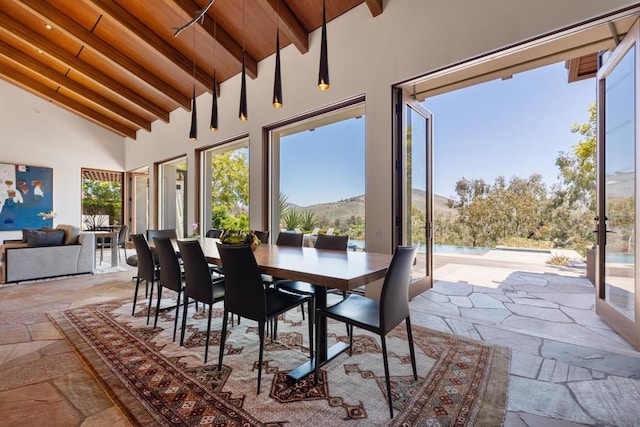 sunroom / solarium with wood ceiling, a mountain view, and vaulted ceiling with beams