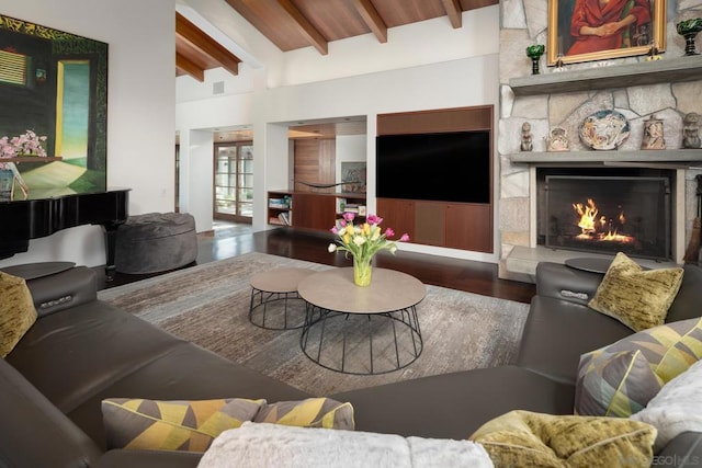 living room with dark wood-type flooring, wooden ceiling, a fireplace, and vaulted ceiling with beams