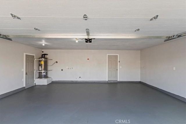 garage featuring water heater and a garage door opener