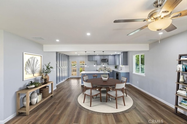 dining space with plenty of natural light, dark wood-type flooring, and sink