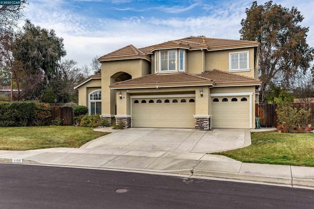 view of front of home featuring a garage and a front lawn