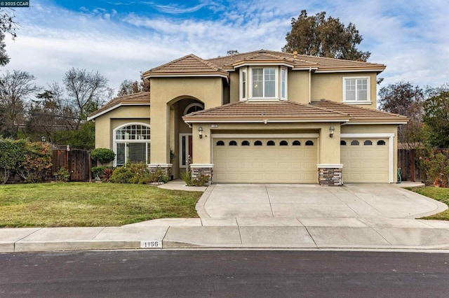 view of front of home featuring a garage and a front lawn